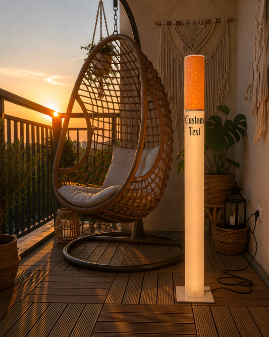 Personalized giant cigarette lamp glowing on a balcony at sunset